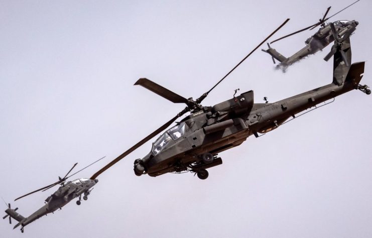 Three Boeing AH-64 Apaches in flight