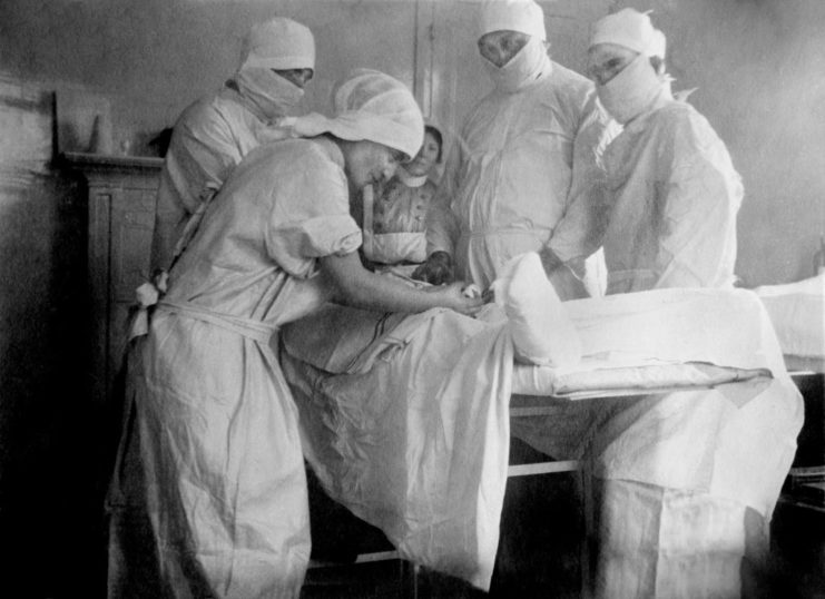 Surgeons performing a foot amputation on a patient