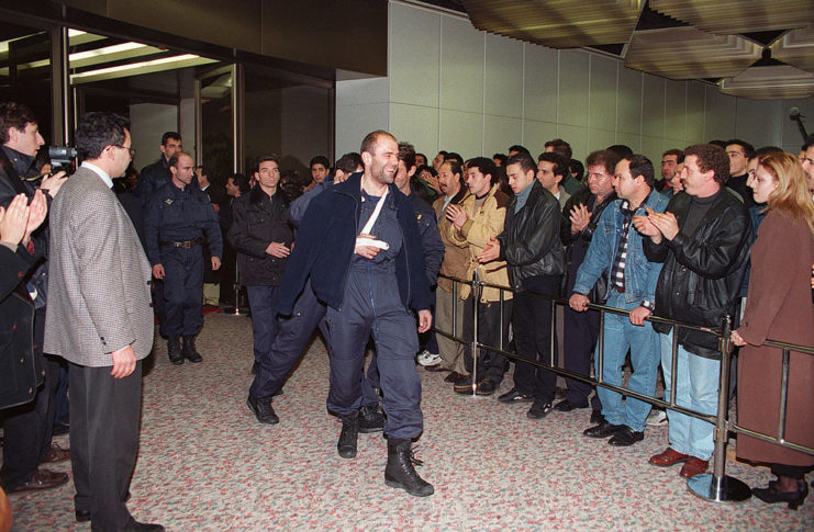 GIGN member walking by family members of the hostages from the hijacked Air France Flight 8969