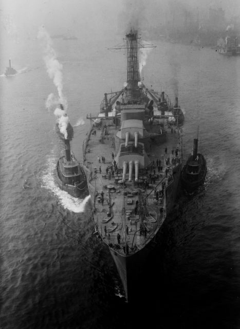 USS Nevada (BB-36) and three smaller vessels leaving port