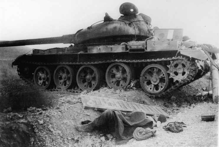 T-62 tank driving over scattered debris