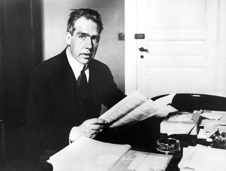 Niels Bohr sitting at his desk