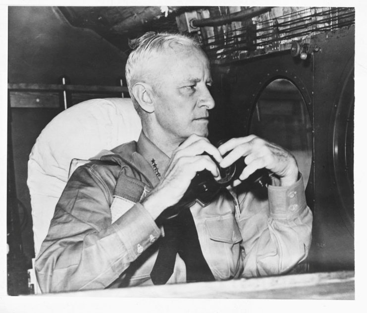 Chester Nimitz holding a pair of binoculars