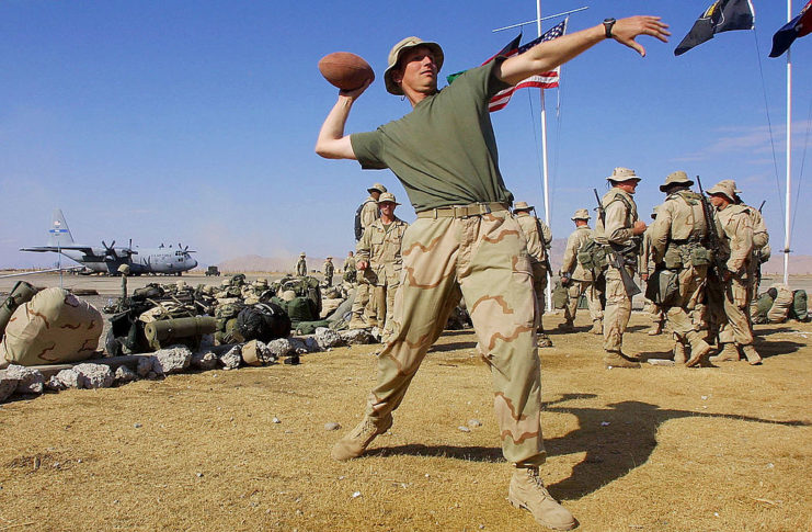 US Soldier throwing a football