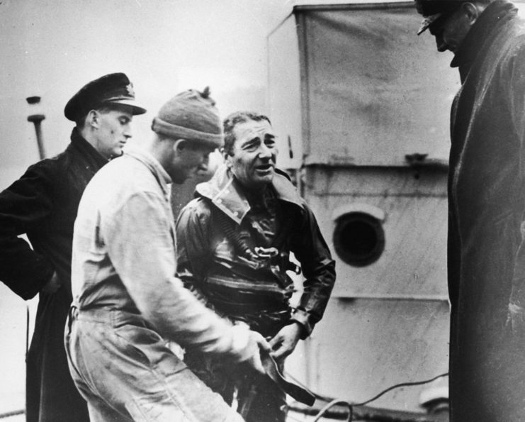 Lionel Crabb standing with three other men