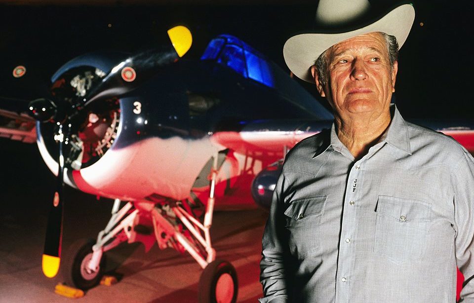 Joe Foss standing in front of an aircraft