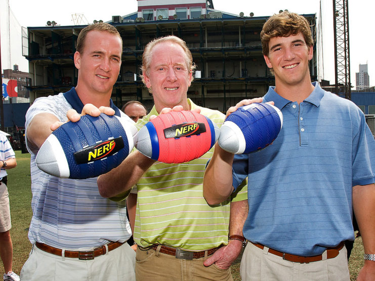 Peyton, Eli and Archie Manning holding Nerf footballs