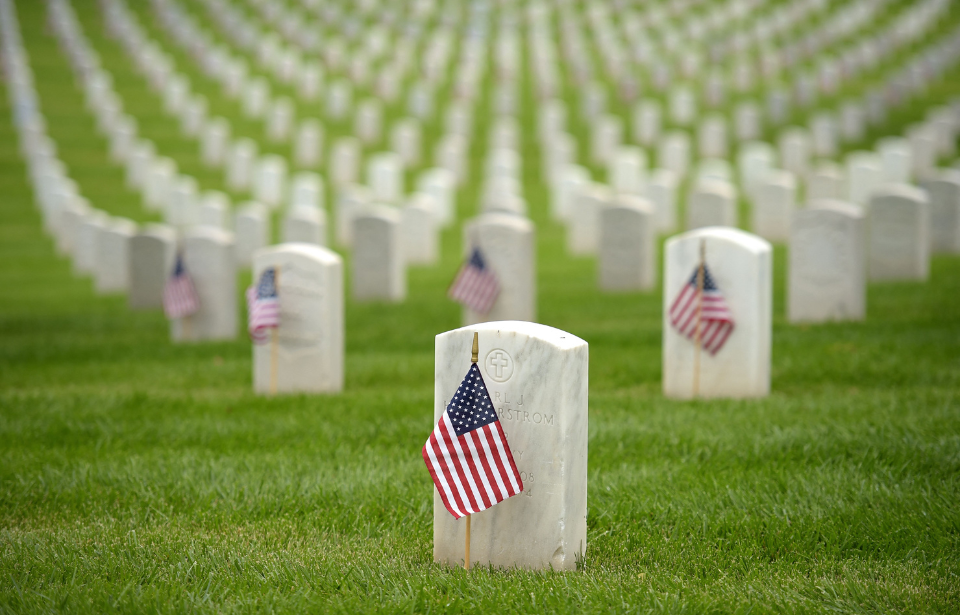 Gravestones adorned with the American flag