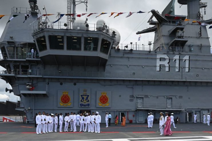 Indian Navy officers standing on the deck of the INS Vikrant