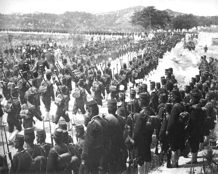 Japanese troops walking across the Korean landscape