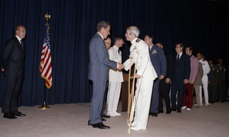 Richard Nixon shaking John McCain's hand