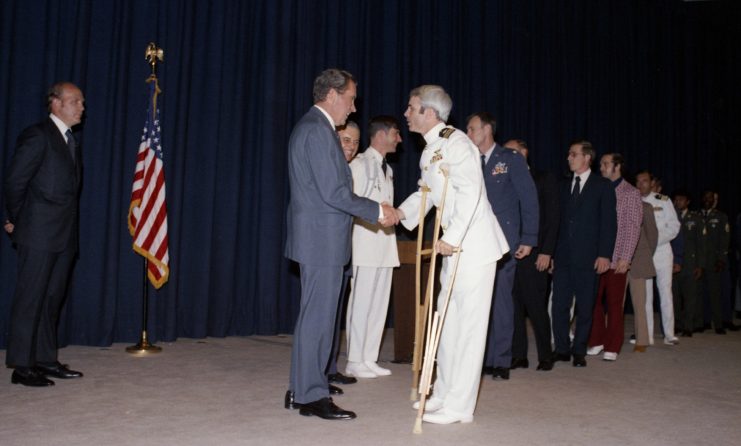 Richard Nixon shaking John McCain's hand