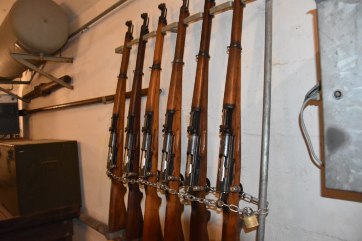 Six Swiss K31 rifles hanging on a wall