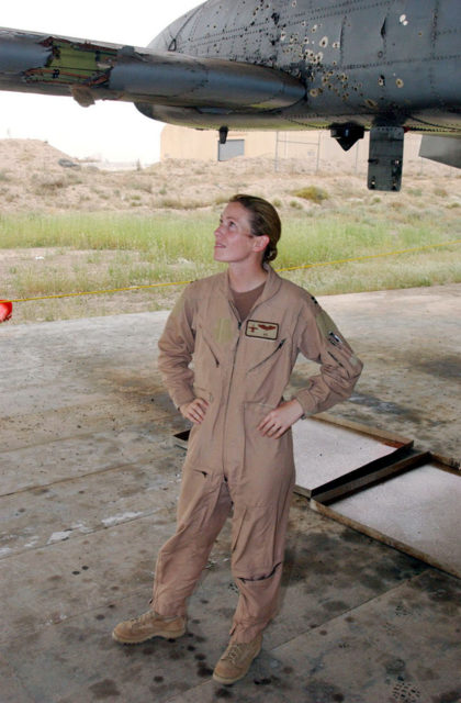 Kim Campbell standing beneath a bullet-ridden Republic Fairchild A-10 Thunderbolt II