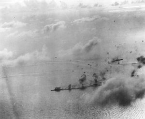 Aerial view of Kongō shrouded in smoke while at sea