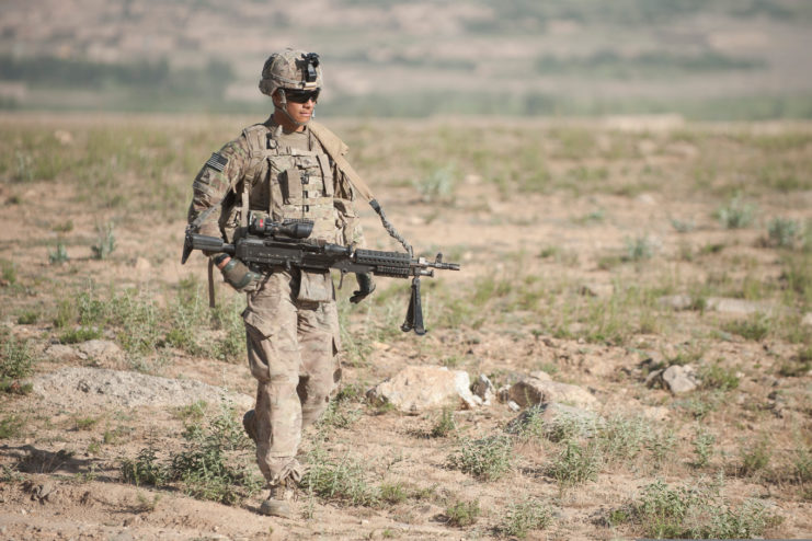 Pfc. Michael Andrade patrolling while equipped with an M240L