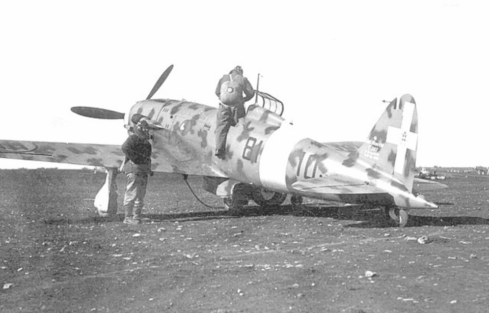 Italian pilot climbing into the cockpit of a Macchi C.202 Folgore