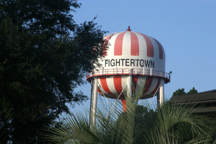 Red and white striped water tower with "FIGHTERTOWN" written across it in black