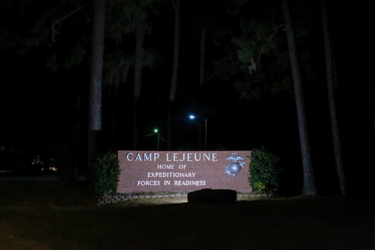 Entrance sign for Marine Corps Base Camp Lejeune, North Carolina lit at night