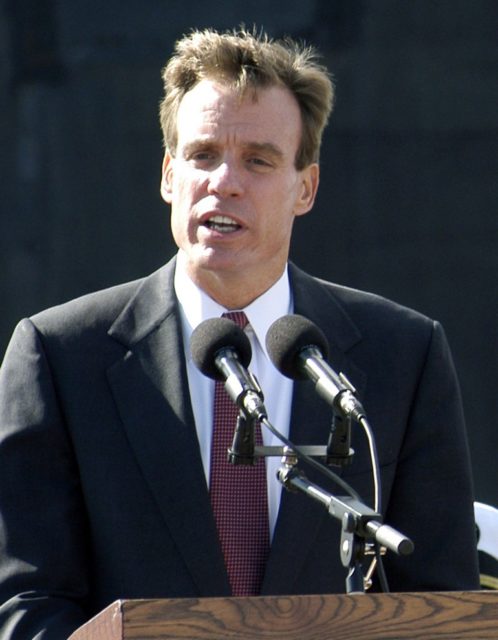 Mark Warner speaking at a podium