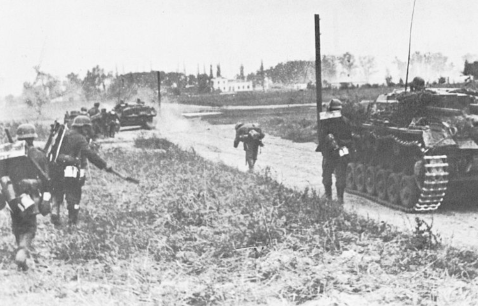 German soldiers running down a dirt road