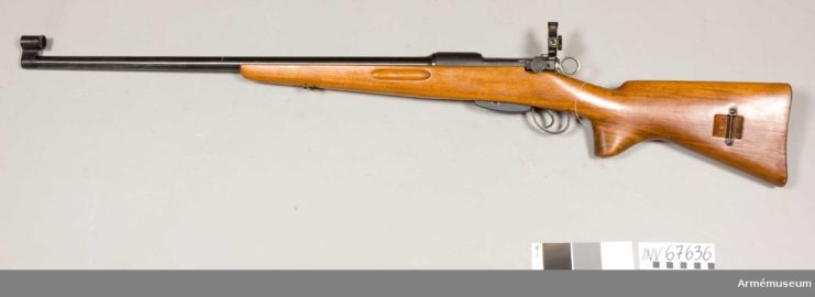 Swiss K31 rifle against a beige backdrop