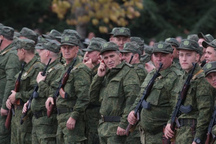 Men drafted as part of Russia's mobilization efforts standing together in uniform