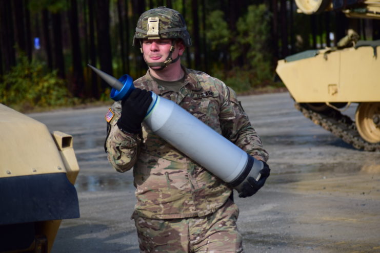 Sgt. Devon Myers carrying a sabot round