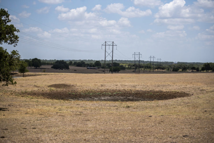 Dried-up pond in the middle of a farmer's field