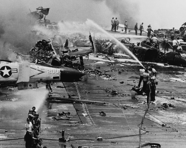 Crewmen putting out fires on the flight deck of the USS Forrestal (CV-59)