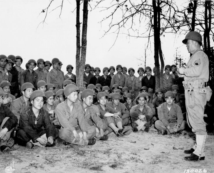 Members of the 100th Infantry Battalion being addressed by a superior