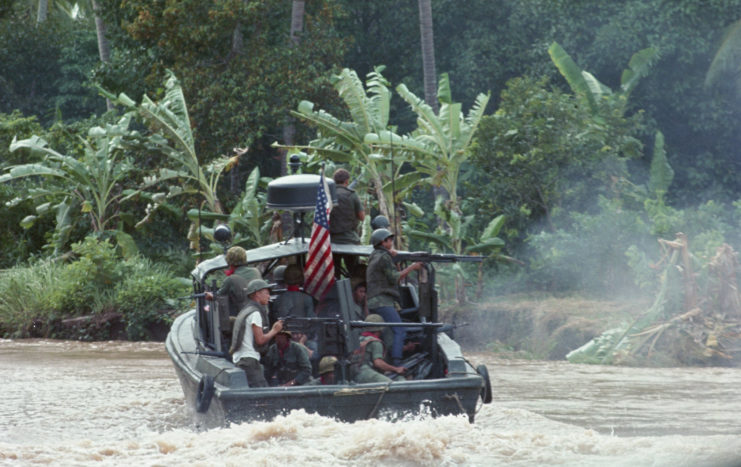 US Navy sailors manning weapons onboard a Patrol Boat, Riverine (PBR)