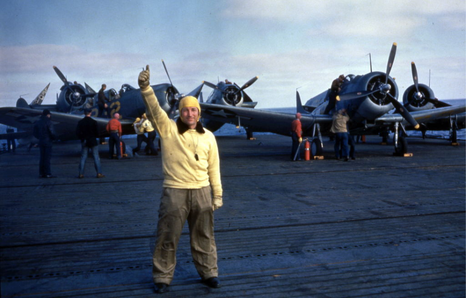 Crewman standing in front of a number of Douglas SBD Dauntless dive bombers