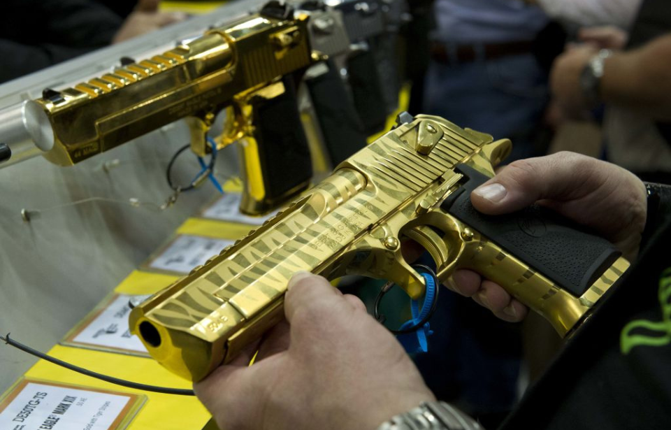 Two gold-plated Desert Eagles on display