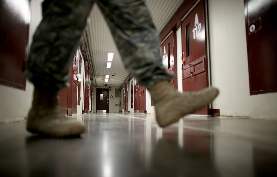 Officer walking across a hallway in a military prison