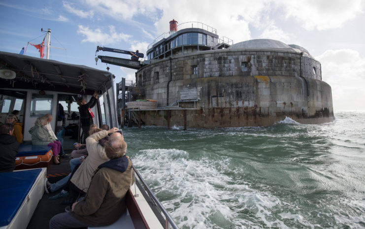 Visitors sailing on a boat as it passes Spitbank Fort