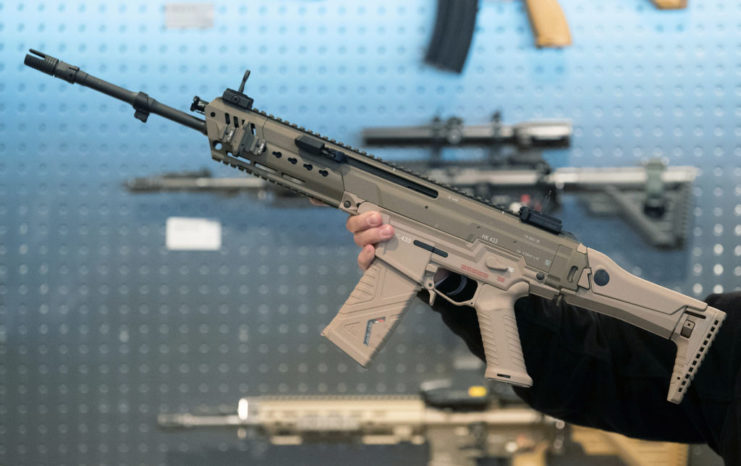 A man holds a HK433 rifle