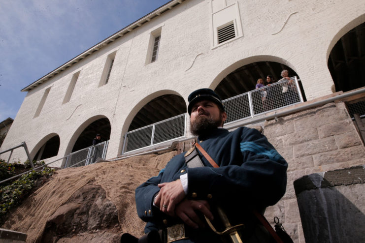 Re-enactor standing in front of Alcatraz Island's Guardhouse Complex while dressed as an American Civil War soldier