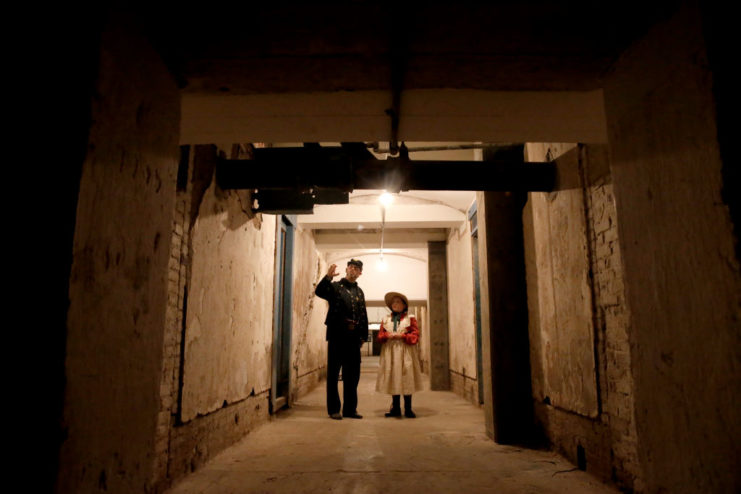 Two American Civil War re-enactors standing in the middle of an underground hallway