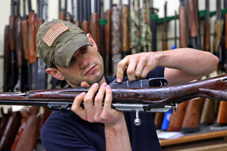 Man inspecting a Mosin-Nagant