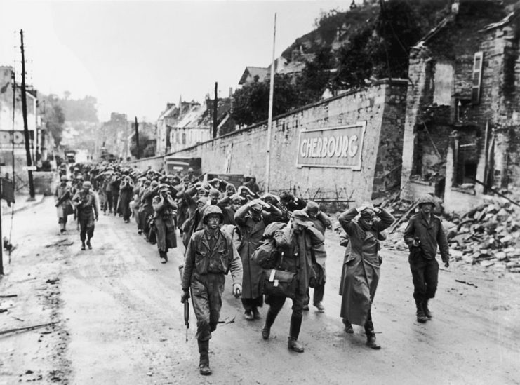 German soldiers marching along a street in Cherbourg, France