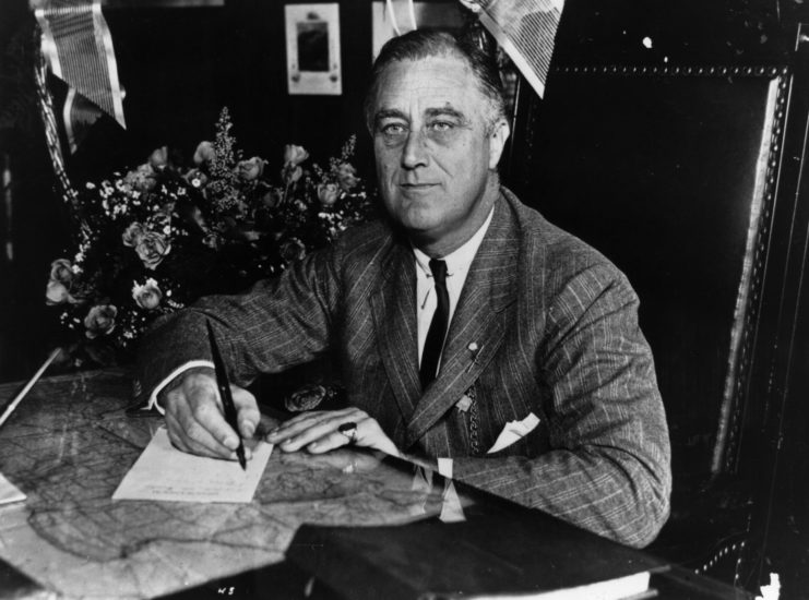 Franklin D. Roosevelt writing a note at his desk