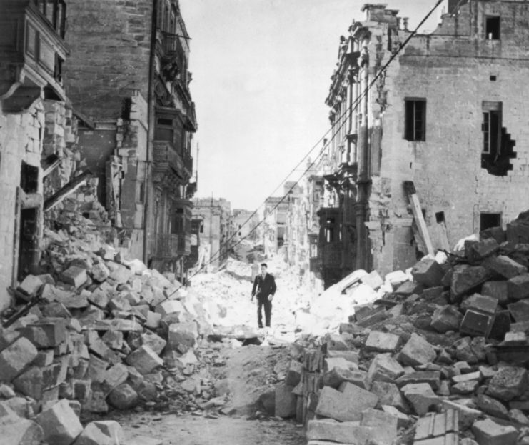 A man walks through the aftermath of bombing on a street