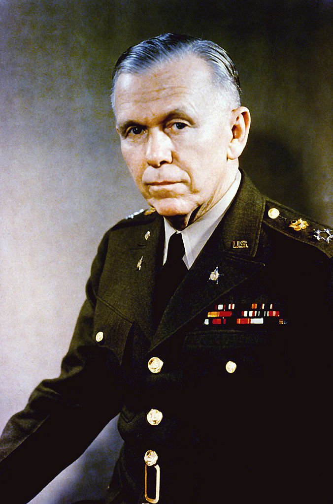 George Marshall sitting for a portrait while scowling, wearing military dress.