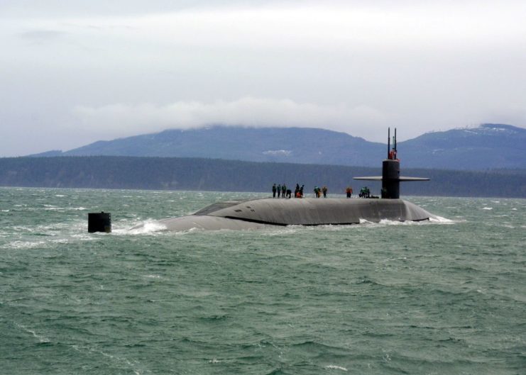 Crew members standing on top of the USS Ohio (SSGN-726) while she's at sea