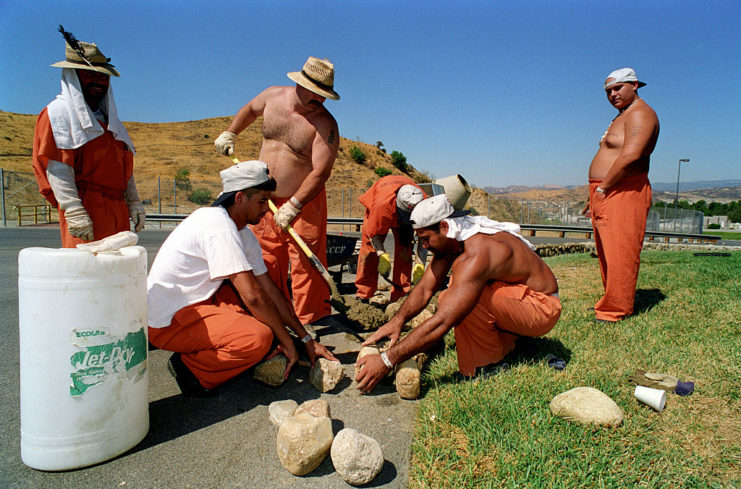 Six prisoners standing together outside