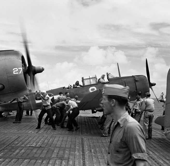 Crewmen securing a Douglas SBD Dauntless onboard the USS Yorktown (CV-5)