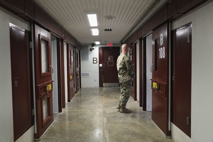 Soldier standing in the middle of a hallway at the Guantanamo Bay detention camp