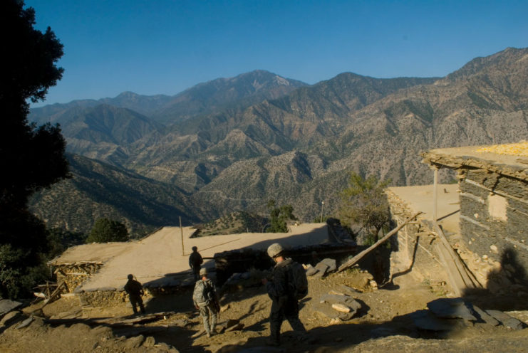 Soldiers with First Platoon, Company B, 173rd Division walking through the village of Hanek Bandeh