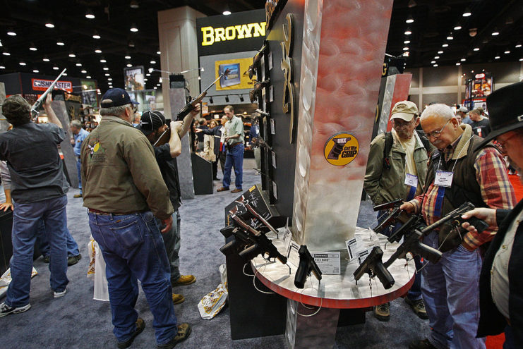 Attendees walking around the exhibition hall at a gun show